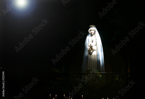madonna staue in church light beam