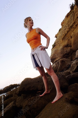 lady standing on the rocks