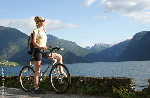 sporty woman on a bike trip in the mountains