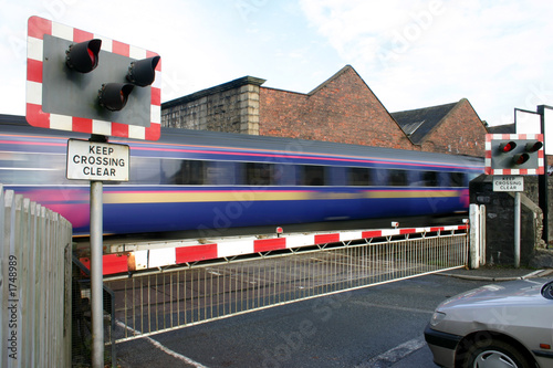 train going through level crossing