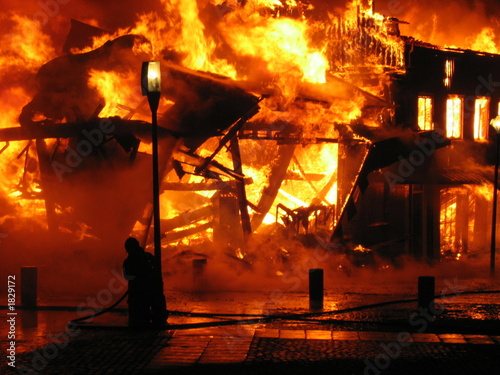 firefighter fighting burning hous