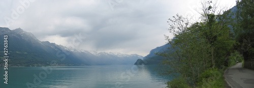 lake interlaken and a shore road with the alps mountains in the
