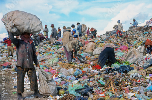 poor people working in a rubbish dump