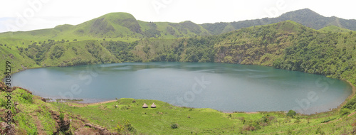 blue lake with green grass around, cameroon, africa, panorama