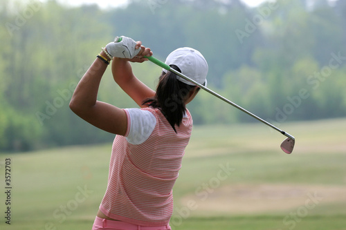 Lady golf swing action at practice 