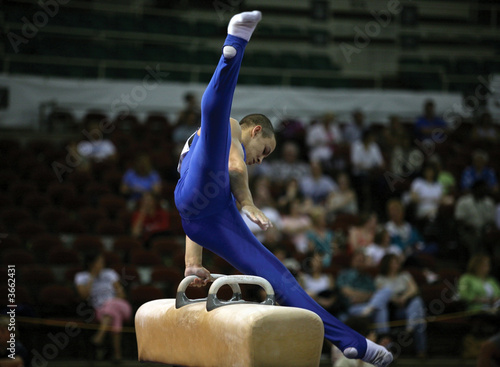 Young man competing on the pommel