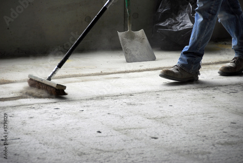 Construction worker sweeping up