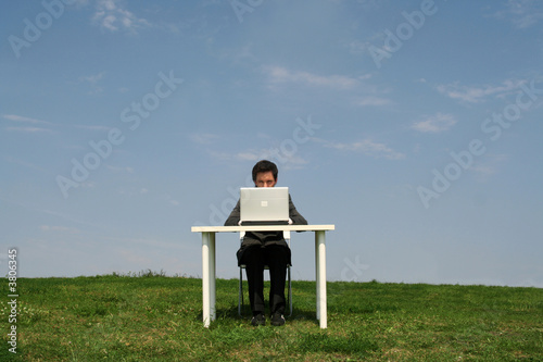 Businessman sitting at desk, outdoors