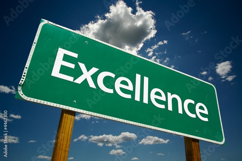 "Excellence" Road Sign with dramatic clouds and sky.