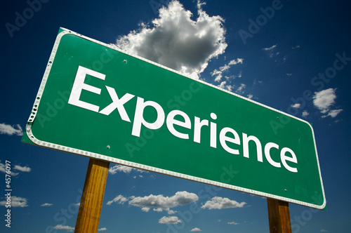 "Experience" Road Sign with dramatic clouds and sky.