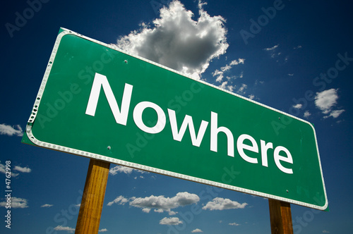 "Nowhere" Road Sign with dramatic blue sky and clouds.