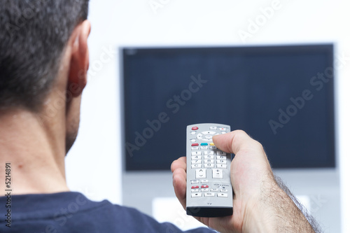 Man with remote control and flat tv