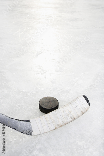 Close up of ice hockey stick on ice rink.