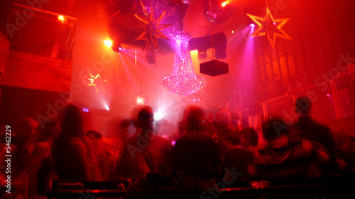 Nightclub scene with christmas decor and dance floor crowd