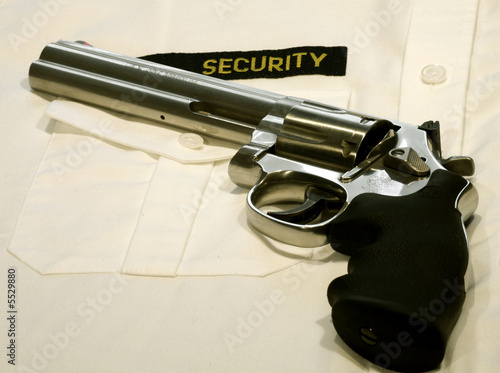 magnum revolver on a white security shirt