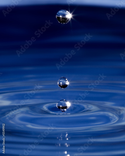 Three water spheres above a wave pattern 