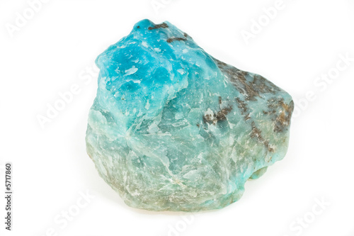 Ornamental stone of turquoise color on a white background