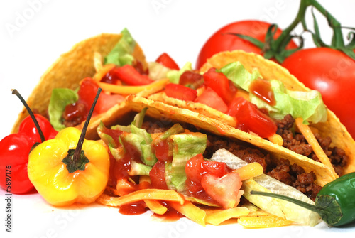 Closeup of tacos with tomatoes, habanero and serano peppers. 