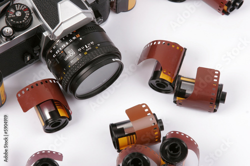 Closeup image of 35mm films and a SLR Camera.