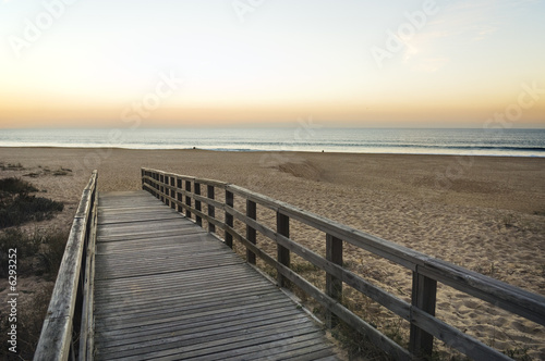 Wooden footbridge leading to the empty beach