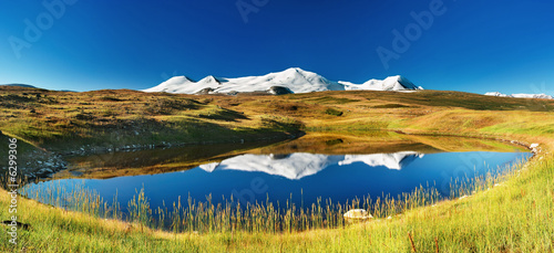 Snowy mountains reflected in lake, Plateau Ukok