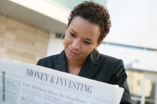 A african american business woman with newspaper