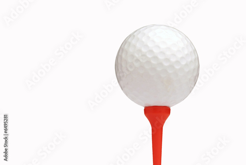 White golf ball on red tee over white