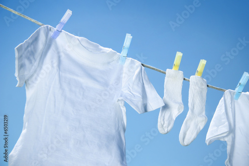Eco friendly laundry drying on clothes line against a blue sky 