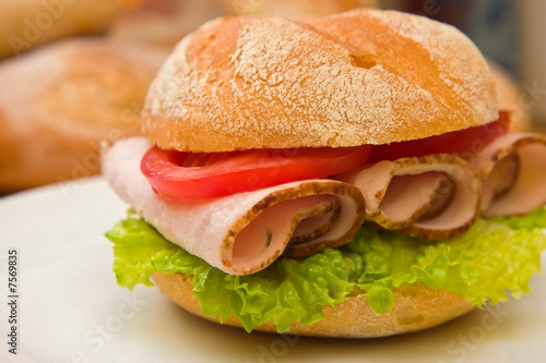 Fresh kaiser bun with turkey breast, lettuce and tomatoes