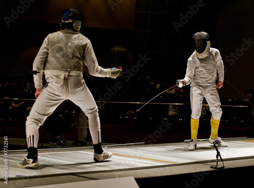 Foil Fencers In A Competitive Bout