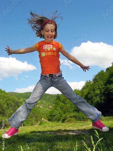 girl happy jumping in spring nature enviroment