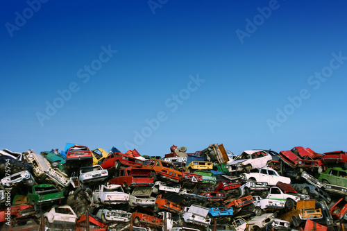 Pile of used cars in junkyard, ready for salvage