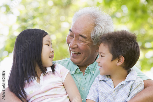 Grandfather laughing with grandchildren