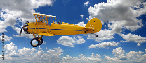 Vintage Biplane Over Clouds