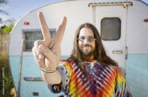 Man in Front of a Trailer Making a Peace Sign