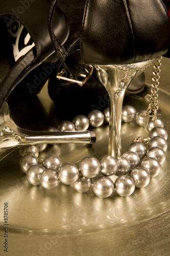 Stilettos and a string of pearls on a tray