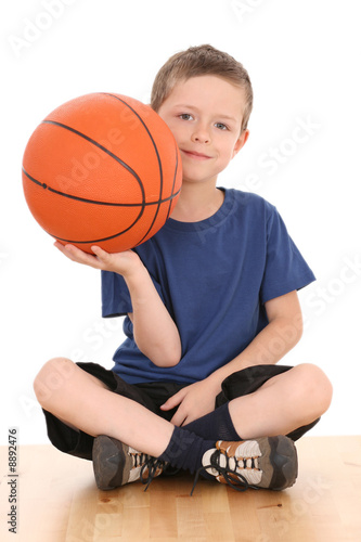 6-7 years old boy with basketball