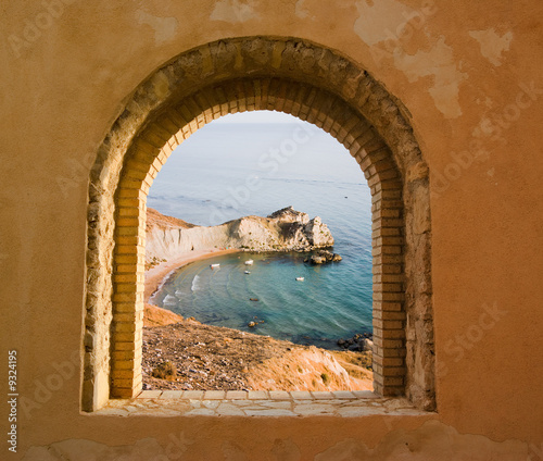 arched window on the coastal landscape of a bay