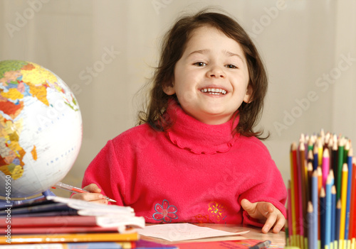 smiling girl learns to spell