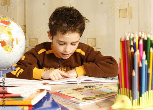 young boy learns to spell