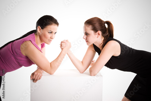 An shot of two businesswomen arm wrestling