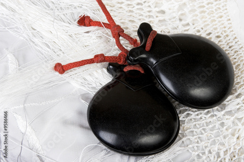 Black spanish castanets on a white shawl