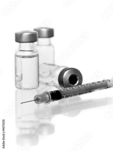 three vials with hypodermic needle