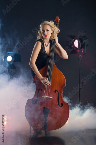 Young woman in studio with contrabass