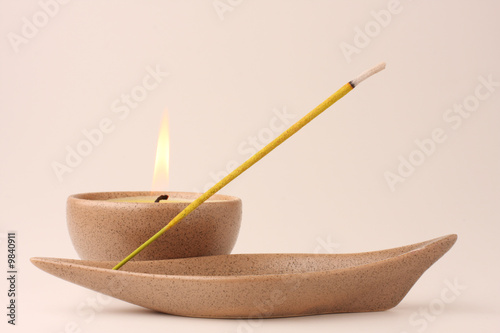 Candle and incense stick in pastel shades