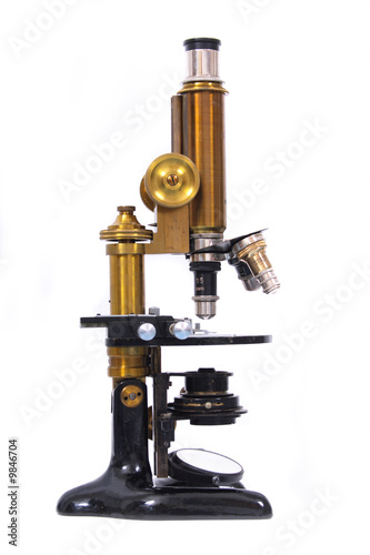 very old microscope on the white background