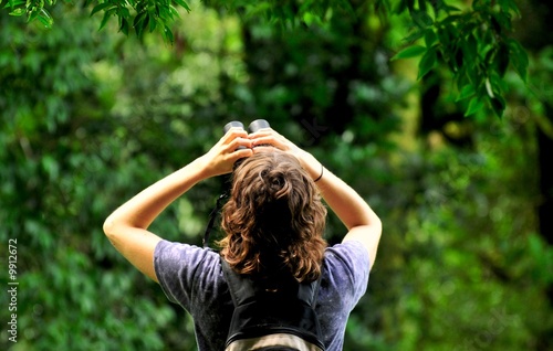 young birdwatcher in tropical forest