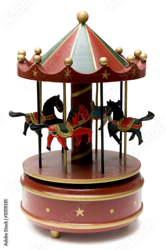 Wooden toy carousel on a white background