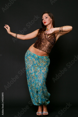 young girl dancing in indian clothes over black