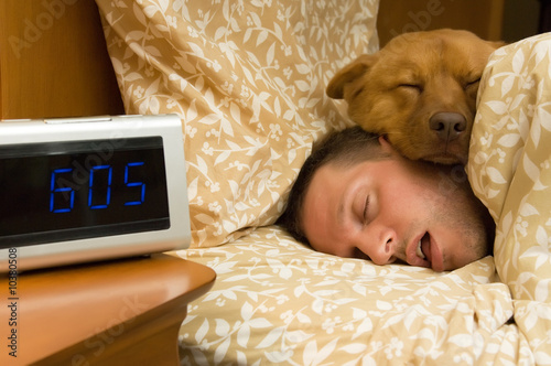 Man and his dog comfortably sleeping in